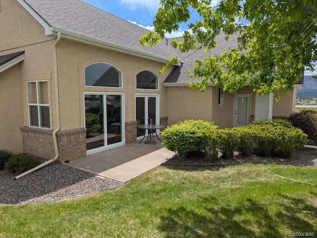 1343 Villa Grv, Monument, CO 80132 - rear view of property with a shingled roof, stucco siding, and a lawn