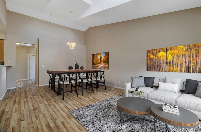 1343 Villa Grv, Monument, CO 80132 - living area with high vaulted ceiling, light wood-type flooring, and a chandelier