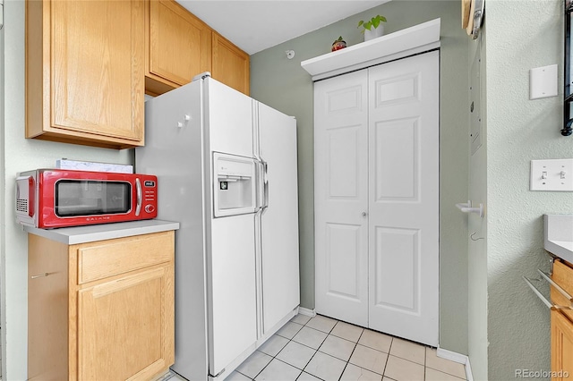 2850 Aurora Ave Unit 301, Boulder, CO 80303 - kitchen featuring white refrigerator with ice dispenser, light tile patterned floors, and light countertops