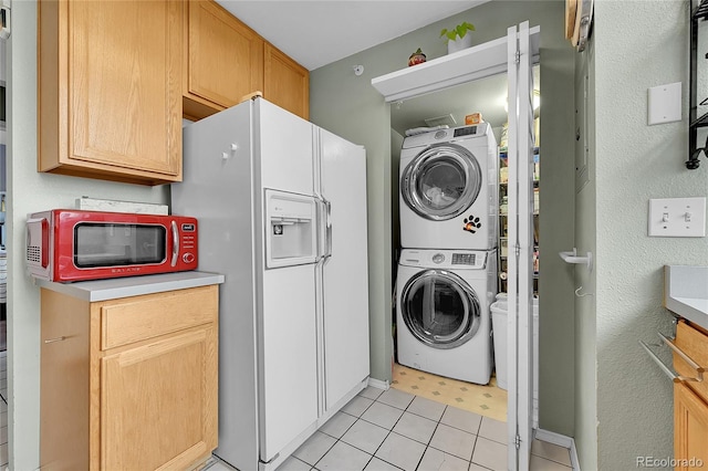 2850 Aurora Ave Unit 301, Boulder, CO 80303 - laundry area with stacked washing machine and dryer and light tile patterned floors