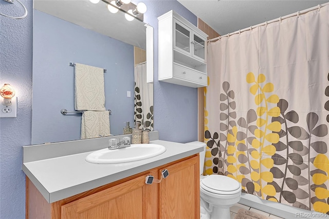2850 Aurora Ave Unit 301, Boulder, CO 80303 - bathroom with a textured wall, vanity, a shower with shower curtain, and tile patterned flooring