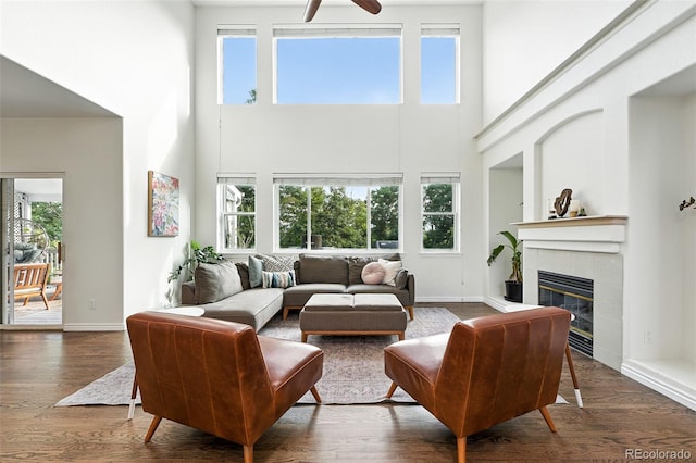 5731 S Yampa St, Centennial, CO 80015 - living room with a towering ceiling, a tiled fireplace, plenty of natural light, ceiling fan, and wood finished floors