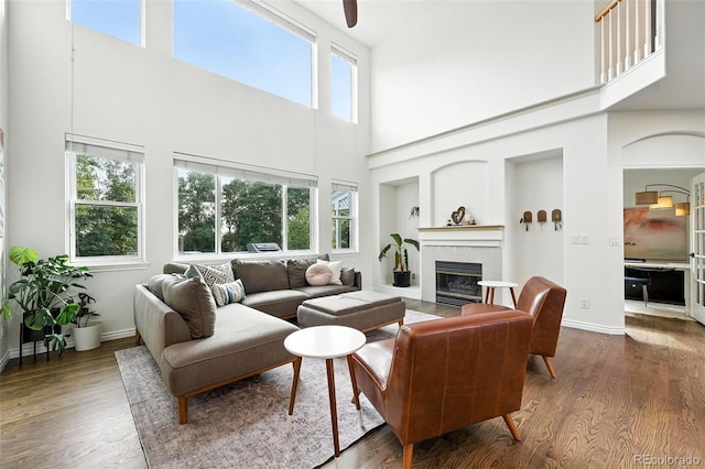 5731 S Yampa St, Centennial, CO 80015 - living room with a high ceiling, a glass covered fireplace, dark wood-type flooring, and plenty of natural light