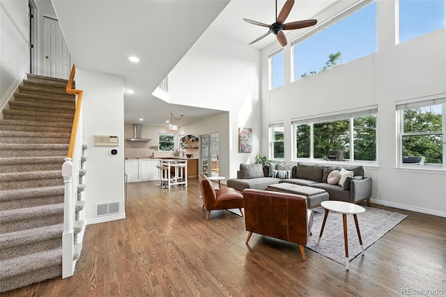 5731 S Yampa St, Centennial, CO 80015 - living room featuring a towering ceiling, dark wood-style floors, plenty of natural light, stairway, and recessed lighting