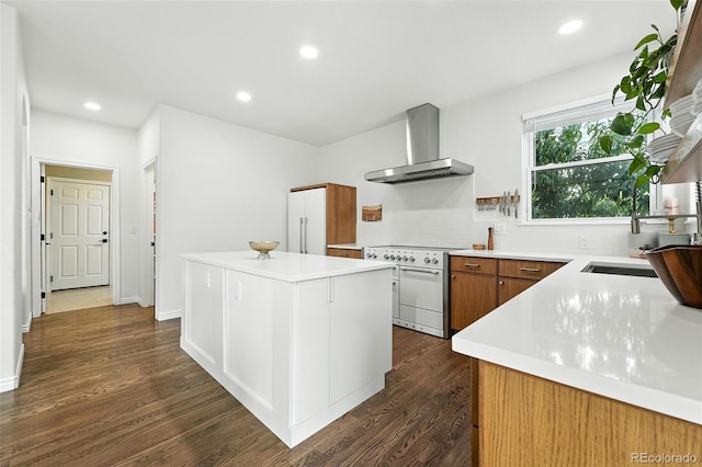 5731 S Yampa St, Centennial, CO 80015 - kitchen with wall chimney exhaust hood, high end range, backsplash, a center island, and light countertops