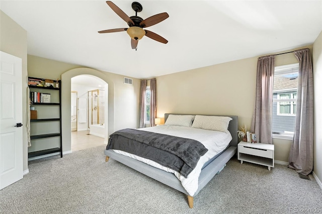 5731 S Yampa St, Centennial, CO 80015 - bedroom featuring carpet flooring, arched walkways, a ceiling fan, and ensuite bath