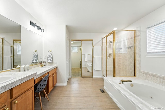 5731 S Yampa St, Centennial, CO 80015 - full bathroom with a shower stall, double vanity, a tub with jets, and healthy amount of natural light