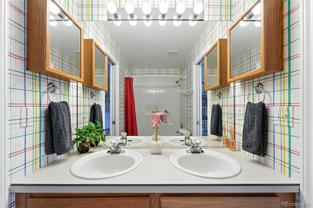 5731 S Yampa St, Centennial, CO 80015 - bathroom featuring a shower, double vanity, and wallpapered walls
