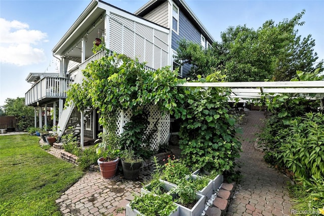 5731 S Yampa St, Centennial, CO 80015 - view of side of home with a garden, stairs, and a wooden deck