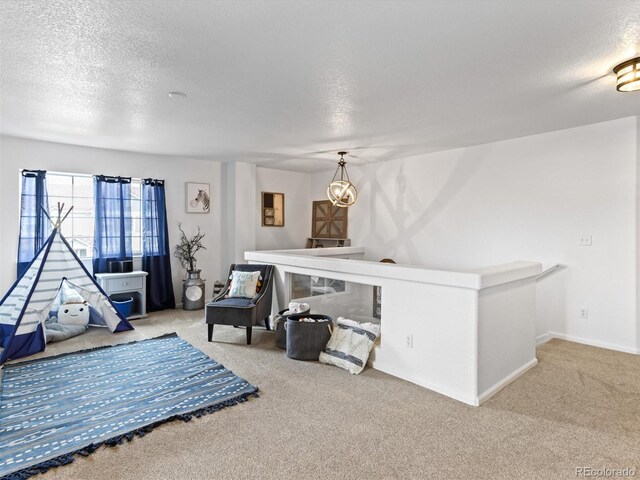 2468 Candleglow St, Castle Rock, CO 80109 - recreation room featuring a textured ceiling, carpet, and baseboards