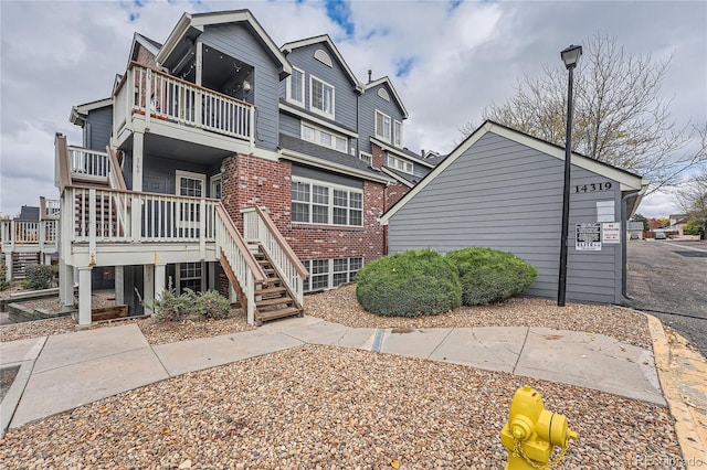 view of side of home with a balcony