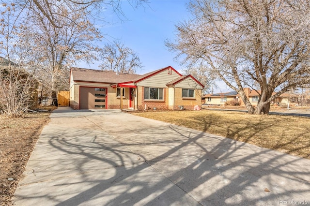 view of front of home with a garage and a front lawn