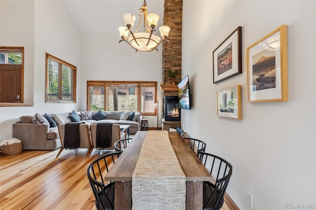 1152 Ski Hill Rd, Breckenridge, CO 80424 - dining area featuring high vaulted ceiling, a chandelier, wood finished floors, and a fireplace