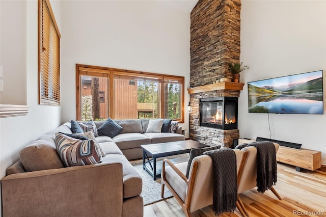 1152 Ski Hill Rd, Breckenridge, CO 80424 - living room featuring a towering ceiling, wood finished floors, and a fireplace