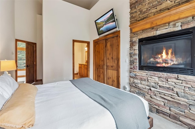 1152 Ski Hill Rd, Breckenridge, CO 80424 - bedroom with a towering ceiling, a glass covered fireplace, and connected bathroom