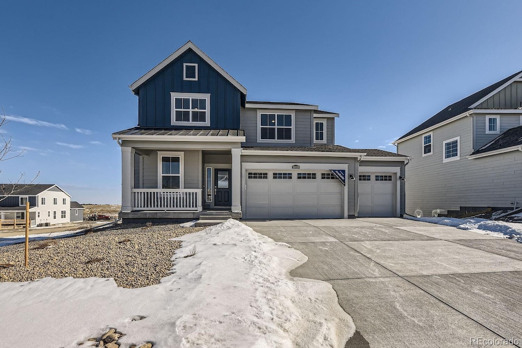 view of front of property featuring a garage and covered porch