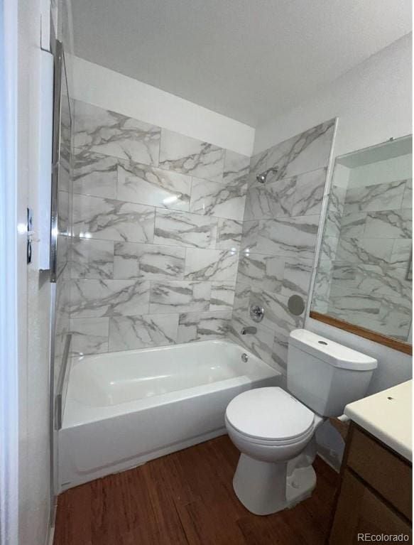 full bathroom with toilet, vanity, tiled shower / bath, and wood-type flooring