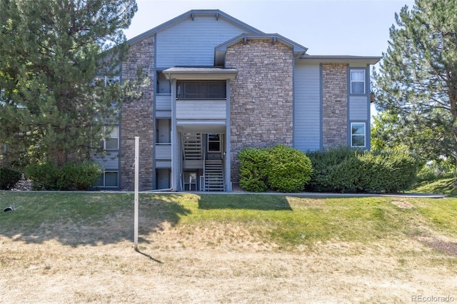 view of front of property with a front yard and stairway