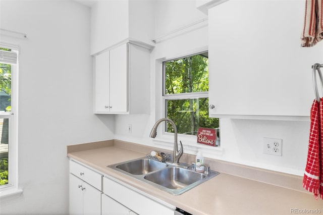 kitchen featuring sink, a healthy amount of sunlight, and white cabinets