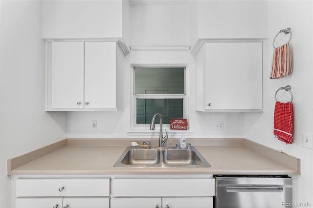 kitchen with sink, stainless steel dishwasher, and white cabinets