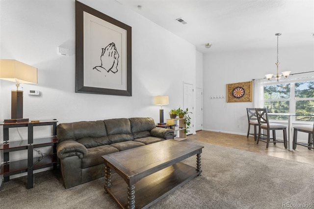 living room featuring high vaulted ceiling and a chandelier