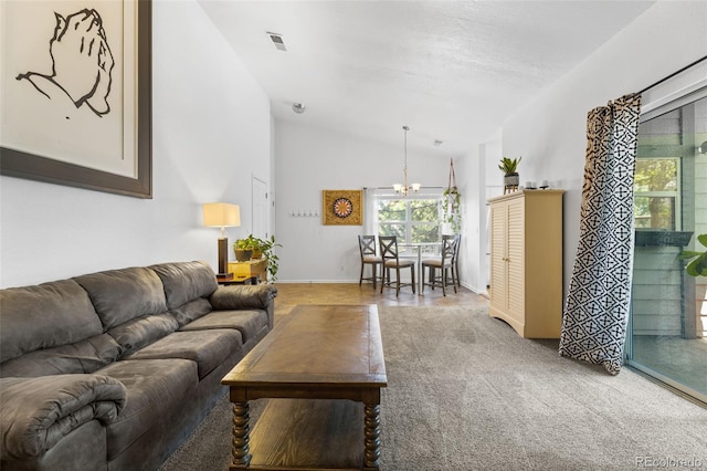 living room with carpet flooring, vaulted ceiling, and a chandelier