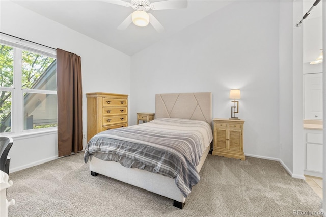 carpeted bedroom featuring lofted ceiling, ceiling fan, and connected bathroom