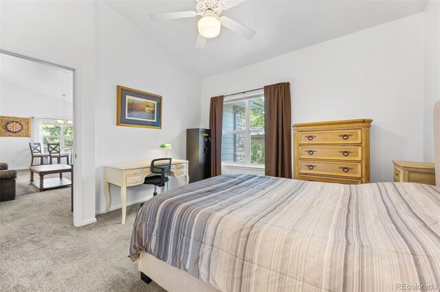 carpeted bedroom featuring lofted ceiling and ceiling fan