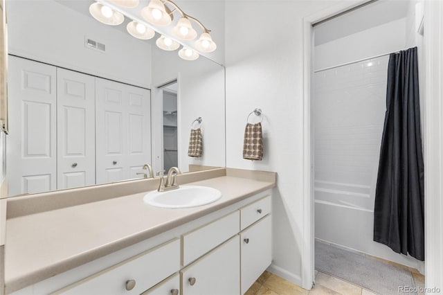 bathroom with tile patterned flooring, vanity, and shower / tub combo with curtain