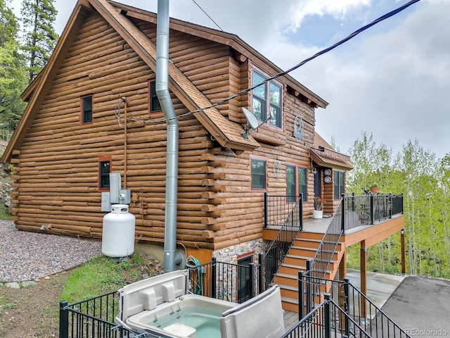 1000 Lodgepole Dr, Evergreen, CO 80439 - back of house with log siding and stairway