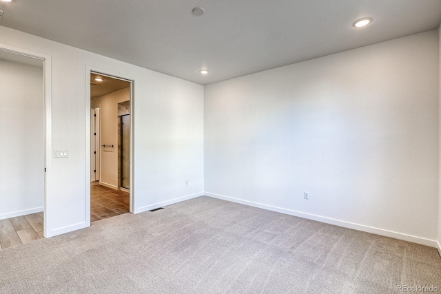 unfurnished room featuring carpet flooring, recessed lighting, and baseboards