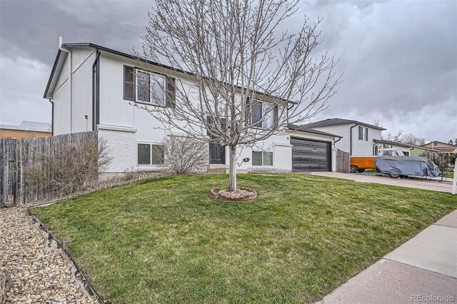view of front of home featuring fence, a front yard, driveway, and a garage