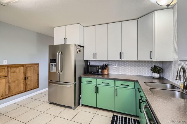 kitchen with a sink, decorative backsplash, stainless steel refrigerator with ice dispenser, and white cabinetry