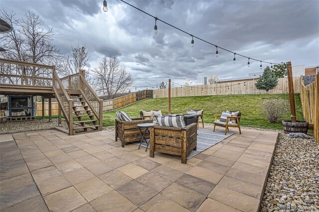 view of patio with a fenced backyard, stairs, and an outdoor living space