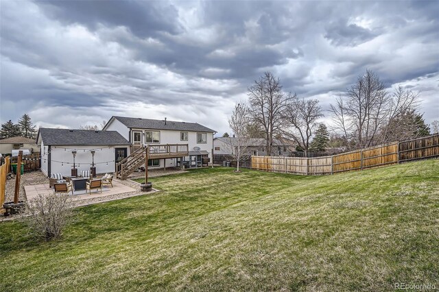 view of yard featuring a deck, a fenced backyard, an outdoor hangout area, stairs, and a patio area