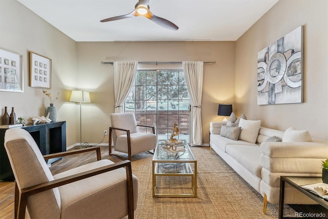 living area with ceiling fan and hardwood / wood-style floors