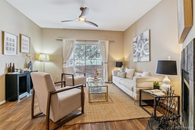 living room featuring ceiling fan and wood-type flooring