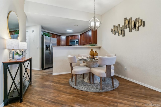 dining area with an inviting chandelier and dark hardwood / wood-style floors