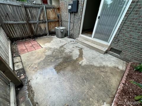 view of patio / terrace with cooling unit and fence