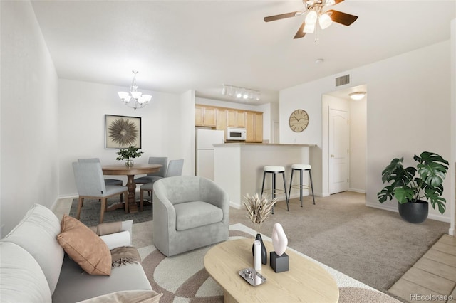 10129 W 55th Dr Unit 3, Arvada, CO 80002 - living room with a chandelier, light colored carpet, ceiling fan, and baseboards