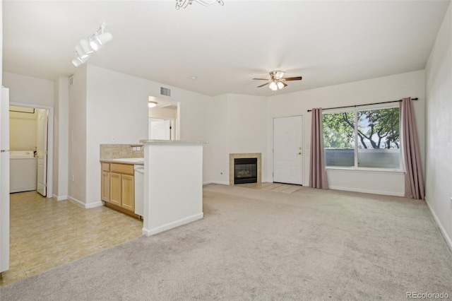 10129 W 55th Dr Unit 3, Arvada, CO 80002 - unfurnished living room with a ceiling fan, a tile fireplace, baseboards, and light carpet
