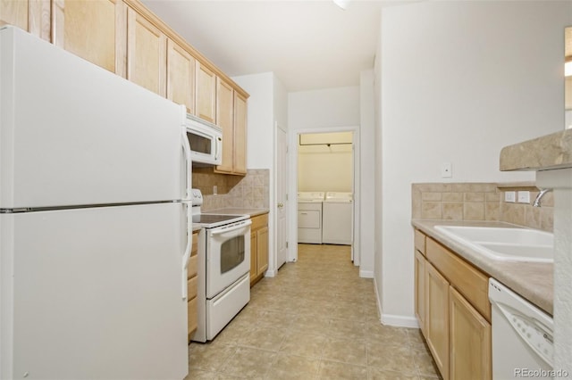 10129 W 55th Dr Unit 3, Arvada, CO 80002 - kitchen featuring white appliances, washing machine and dryer, light brown cabinets, backsplash, and a sink