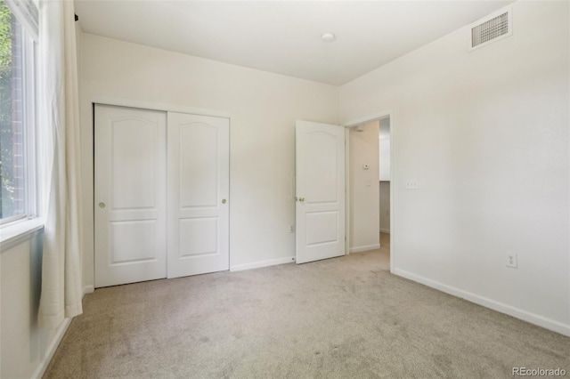 10129 W 55th Dr Unit 3, Arvada, CO 80002 - unfurnished bedroom with carpet floors, multiple windows, a closet, and baseboards
