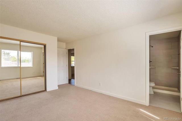 4182 S Joplin St, Aurora, CO 80013 - unfurnished bedroom with carpet flooring, a closet, connected bathroom, baseboards, and a textured ceiling