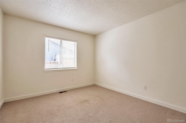 4182 S Joplin St, Aurora, CO 80013 - empty room with light colored carpet, baseboards, and a textured ceiling