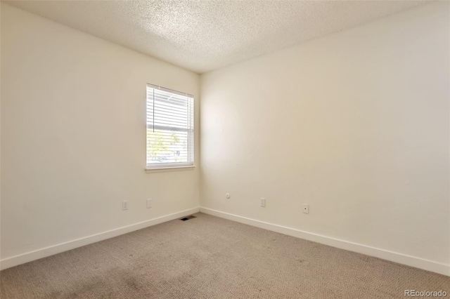 4182 S Joplin St, Aurora, CO 80013 - unfurnished room with baseboards, light carpet, and a textured ceiling