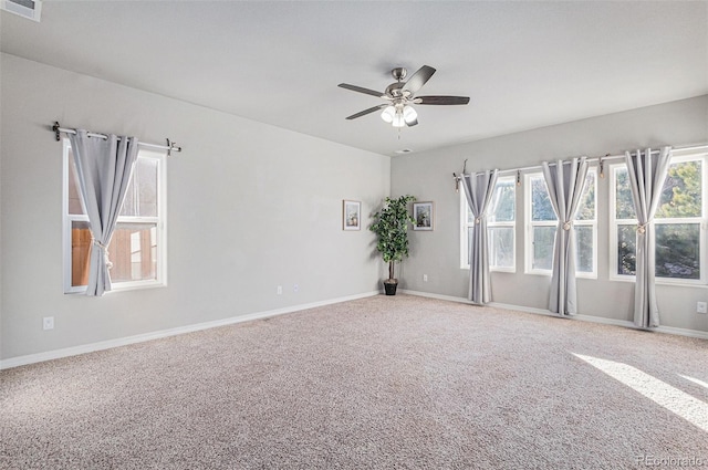 carpeted spare room with ceiling fan