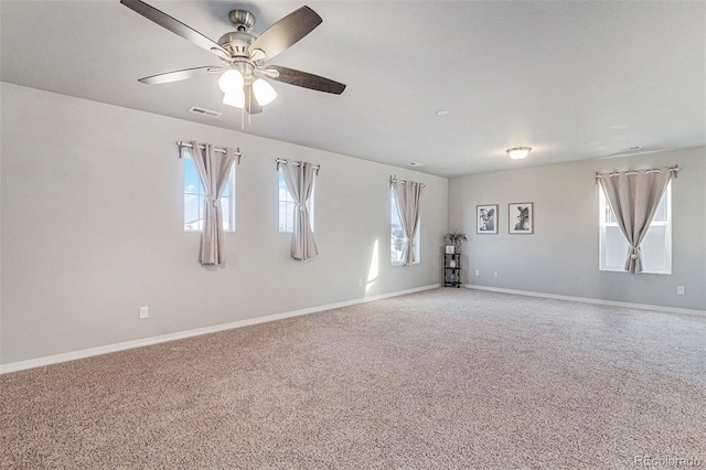 carpeted spare room with ceiling fan