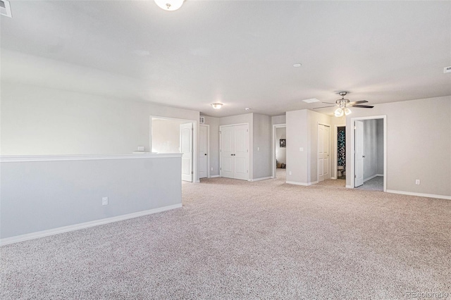 empty room featuring light carpet and ceiling fan