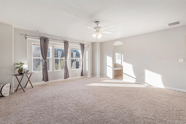 unfurnished living room with carpet flooring and ceiling fan